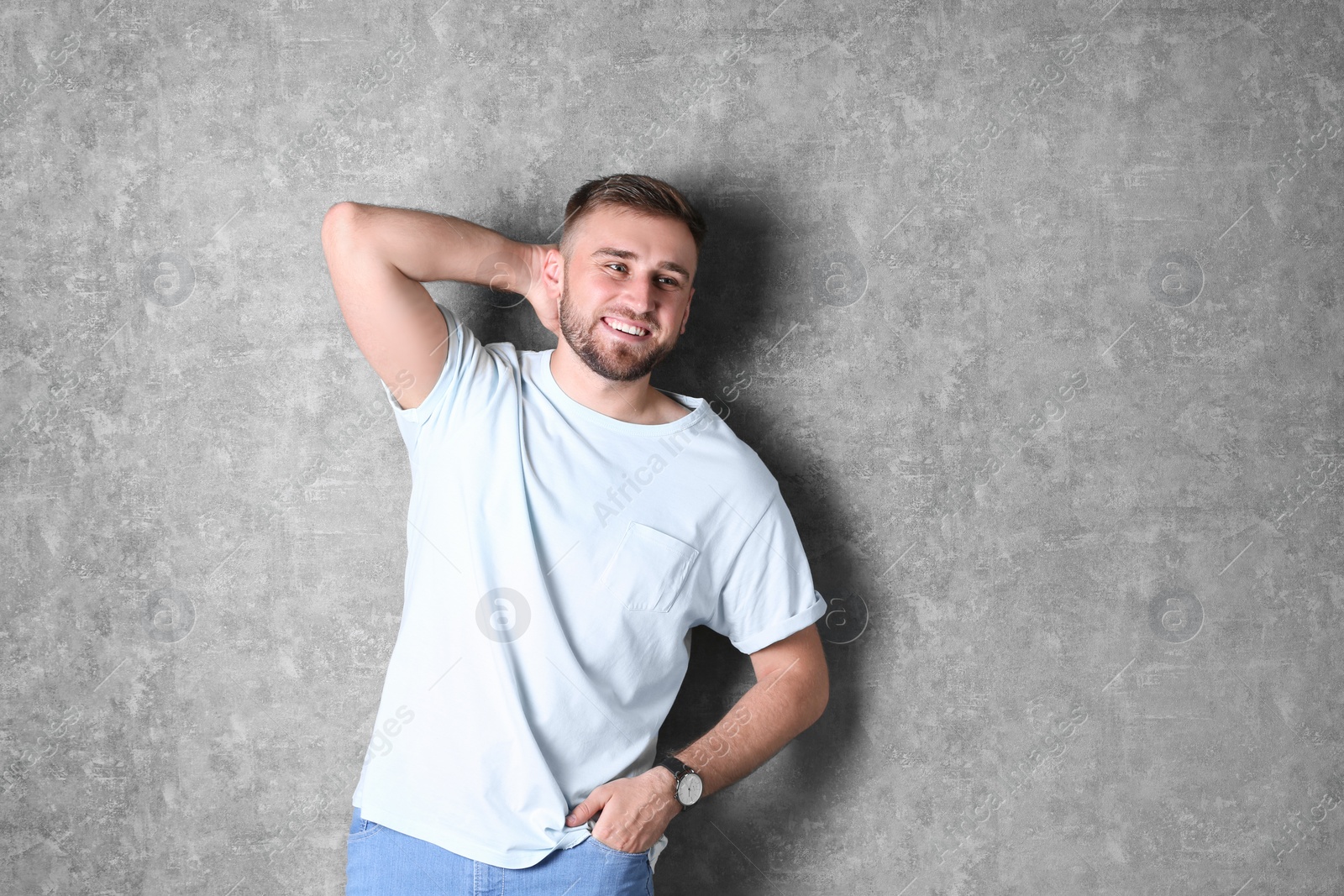 Photo of Portrait of handsome happy man on grey background, space for text