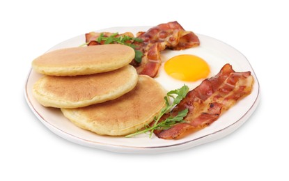 Photo of Plate with tasty pancakes, fried egg, arugula and bacon isolated on white