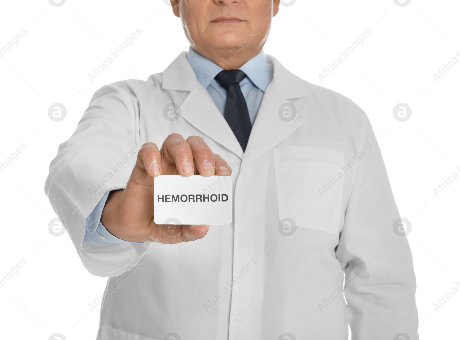 Photo of Doctor holding business card with word HEMORRHOID on white background, closeup
