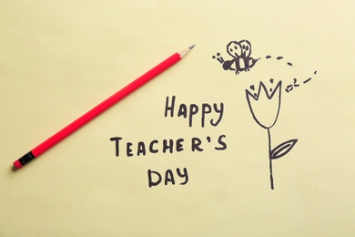 Photo of Pencil, text HAPPY TEACHER'S DAY and drawings on paper