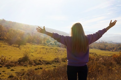 Photo of Female traveler feeling free in peaceful mountains