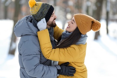 Happy young couple having fun outdoors on winter day