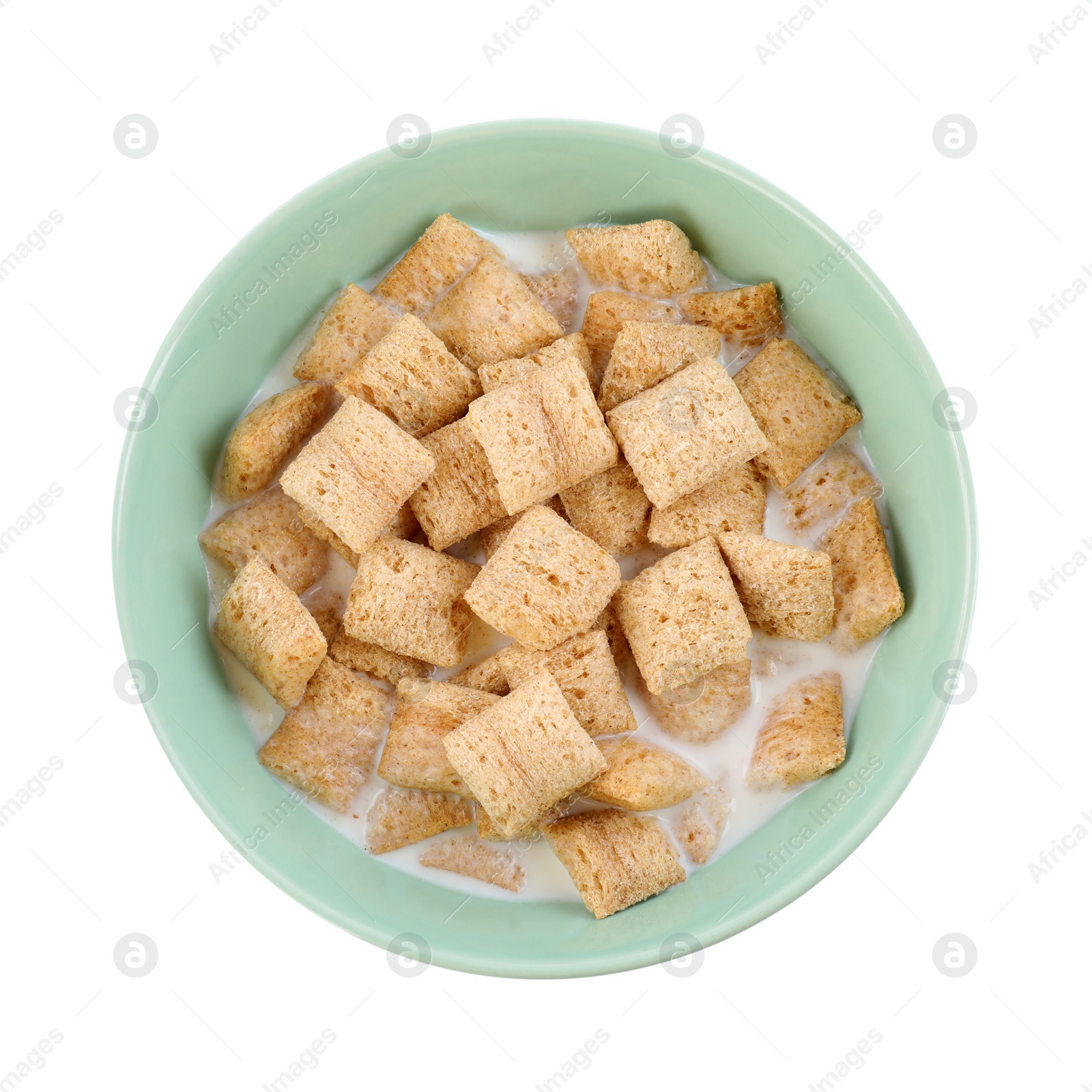 Photo of Tasty corn pads with milk in bowl isolated on white, top view