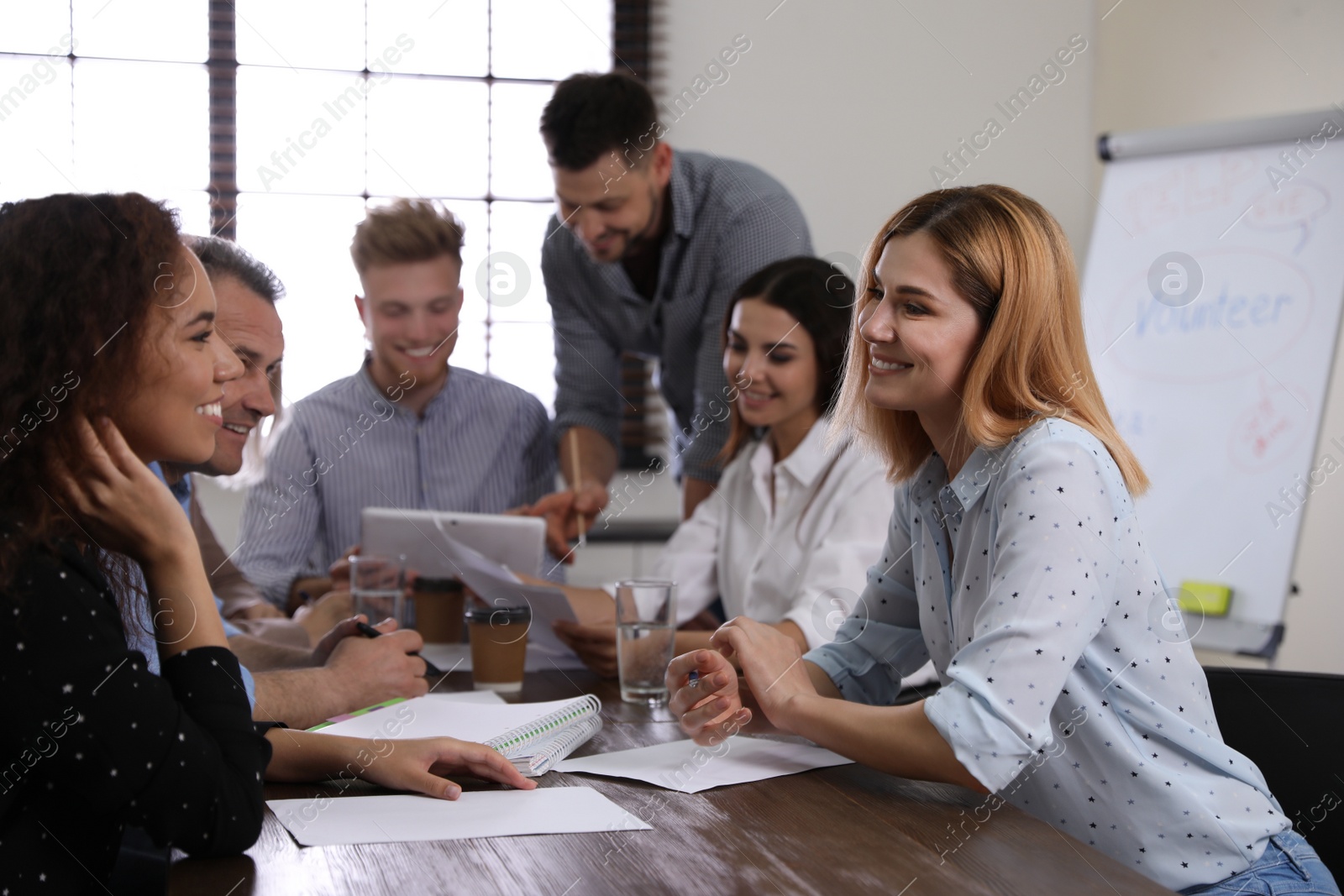 Photo of Portrait of volunteers having meeting in office