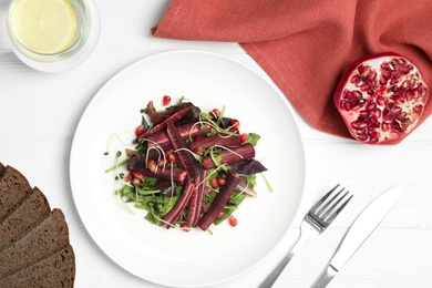 Photo of Delicious fresh carrot salad served on white wooden table, flat lay