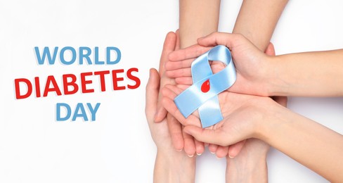 Image of World Diabetes Day. People holding light blue ribbon with paper blood drop on white background, top view 