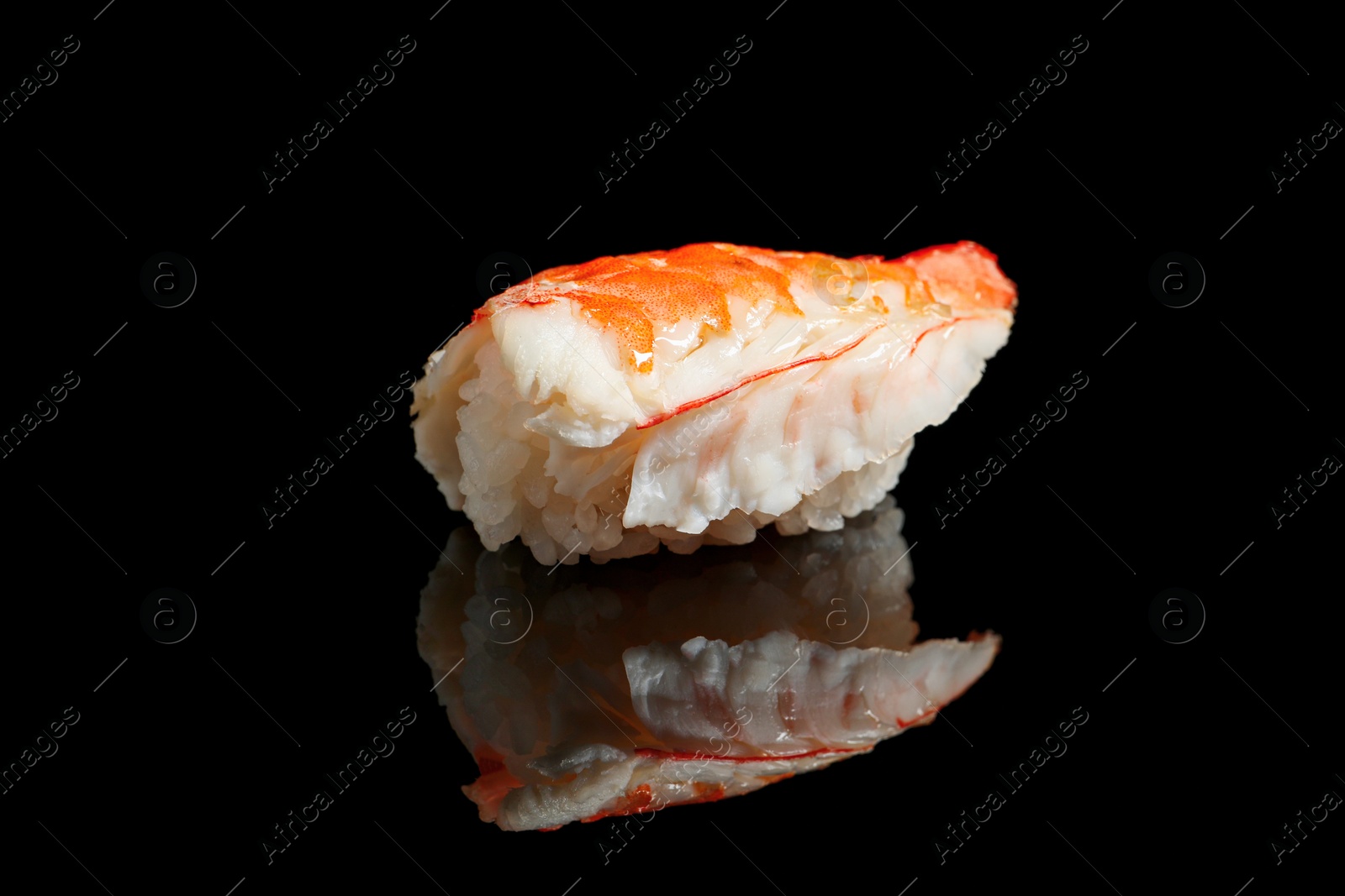Photo of Delicious sushi with shrimp on black background