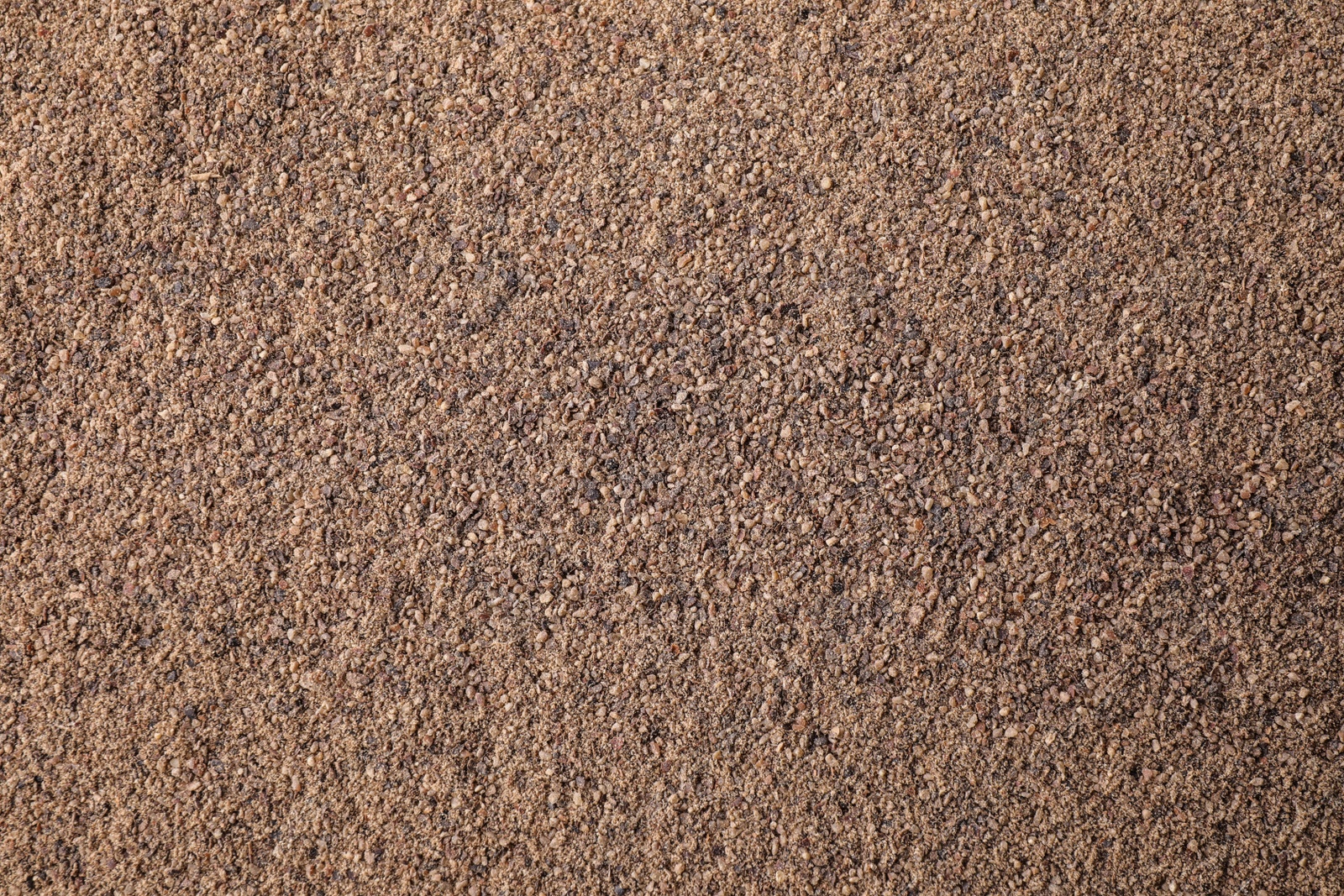 Photo of Milled black pepper as background, top view