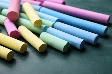 Photo of Pieces of color chalk on greenboard, closeup