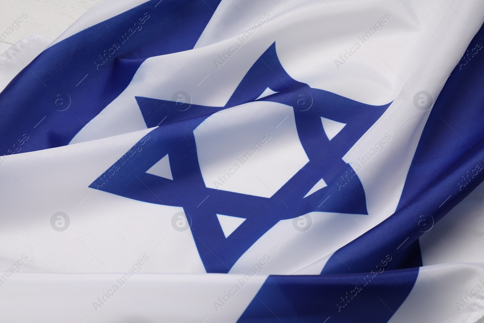 Photo of Flag of Israel on white background, closeup. National symbol