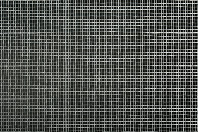 Photo of Closeup view of mosquito window screen on grey background