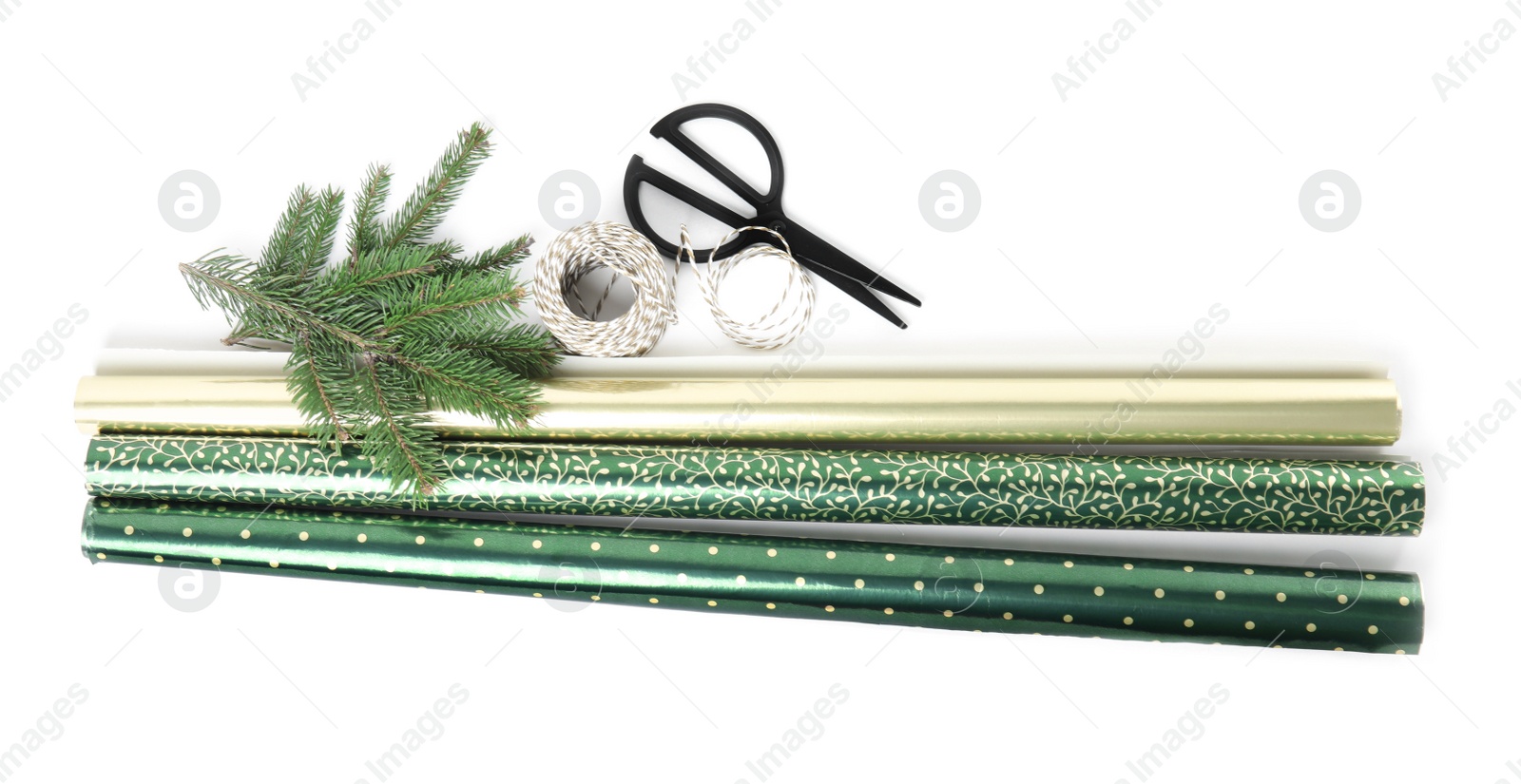 Photo of Wrapping paper rolls, rope, fir branches and scissors on white background, top view