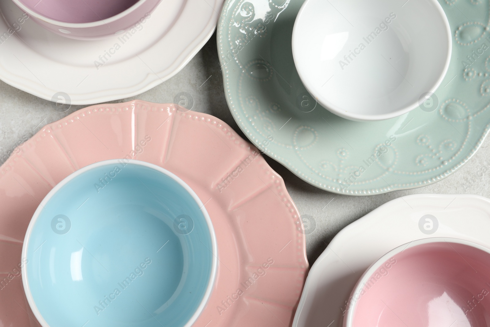 Photo of Beautiful ceramic dishware on light grey table, flat lay