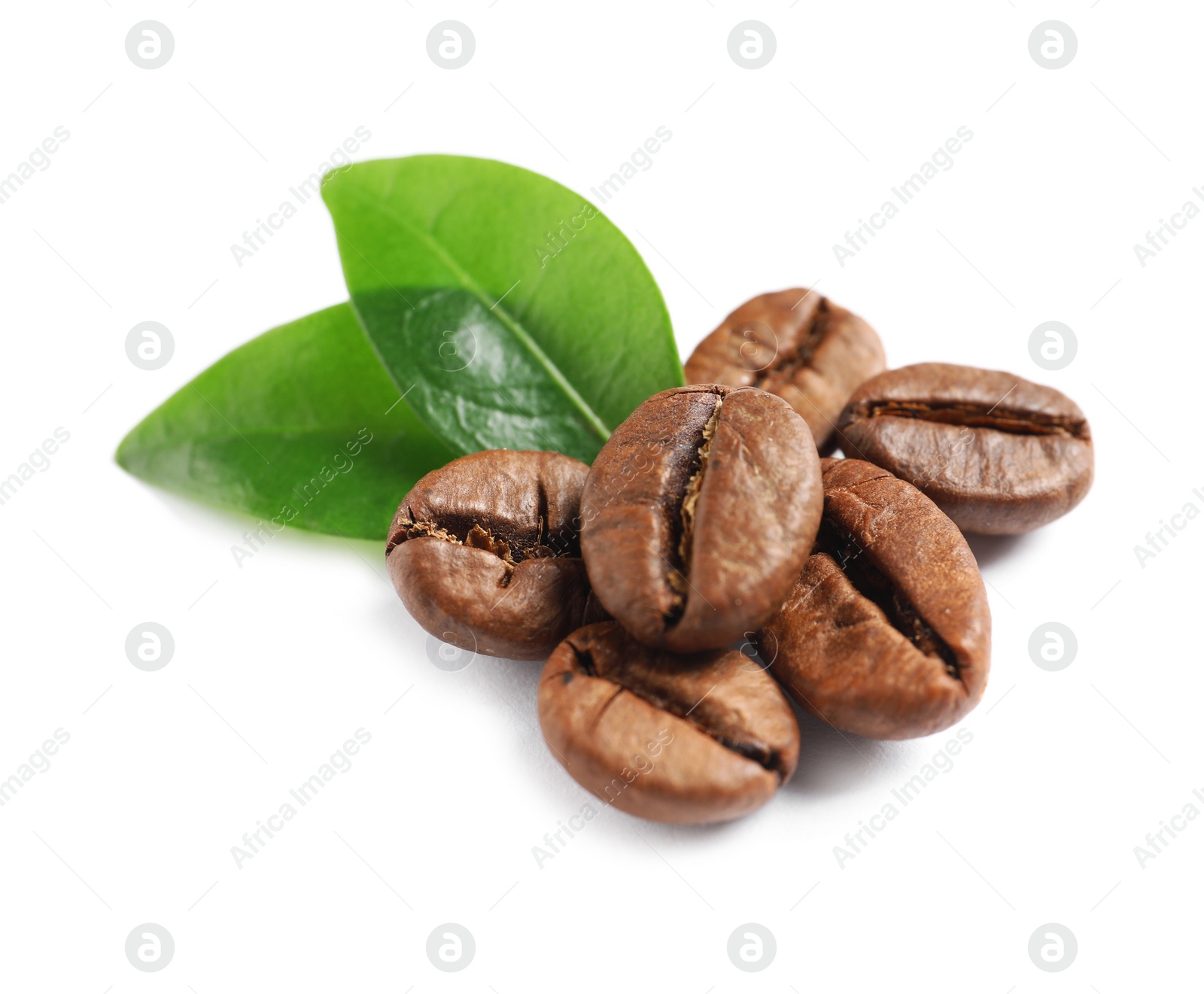 Photo of Roasted coffee beans and fresh green leaves on white background