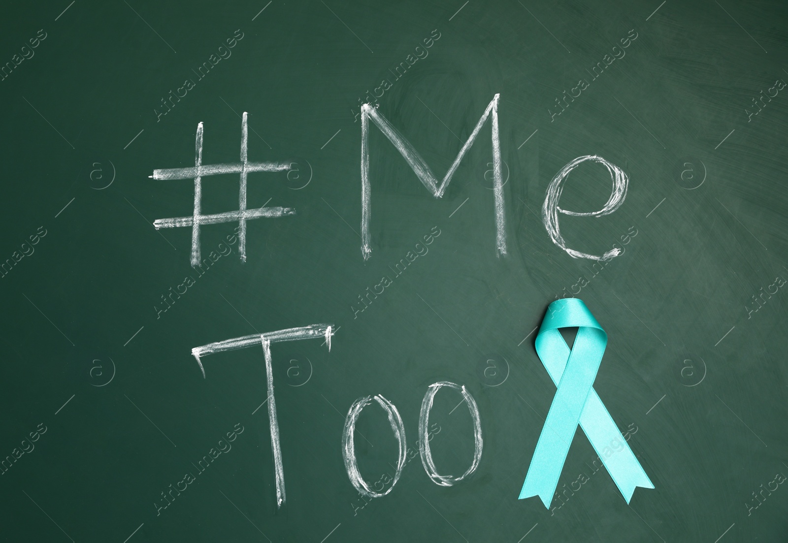 Photo of Teal ribbon and phrase #METOO written on green chalkboard, top view