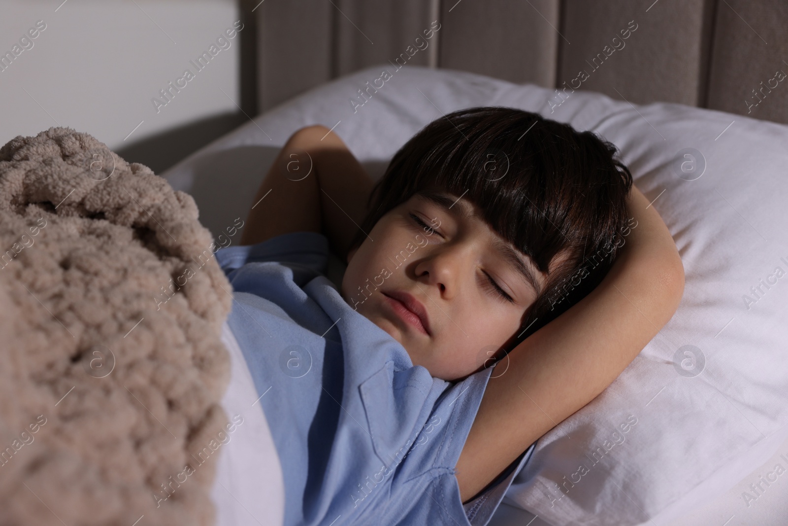 Photo of Cute little boy sleeping in bed at home