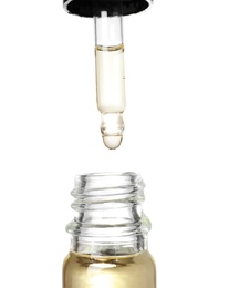 Photo of Bottle and pipette with essential oil on white background, closeup