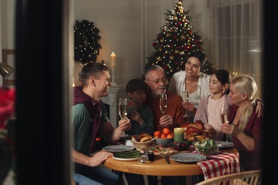 Photo of Happy family enjoying festive dinner at home. Christmas celebration