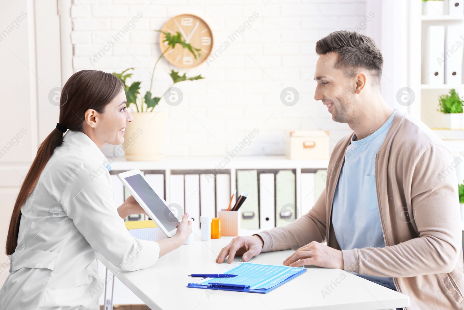 Photo of Female doctor consulting patient in clinic