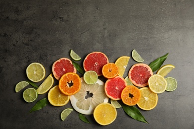 Photo of Different citrus fruits on grey background, top view. Space for text