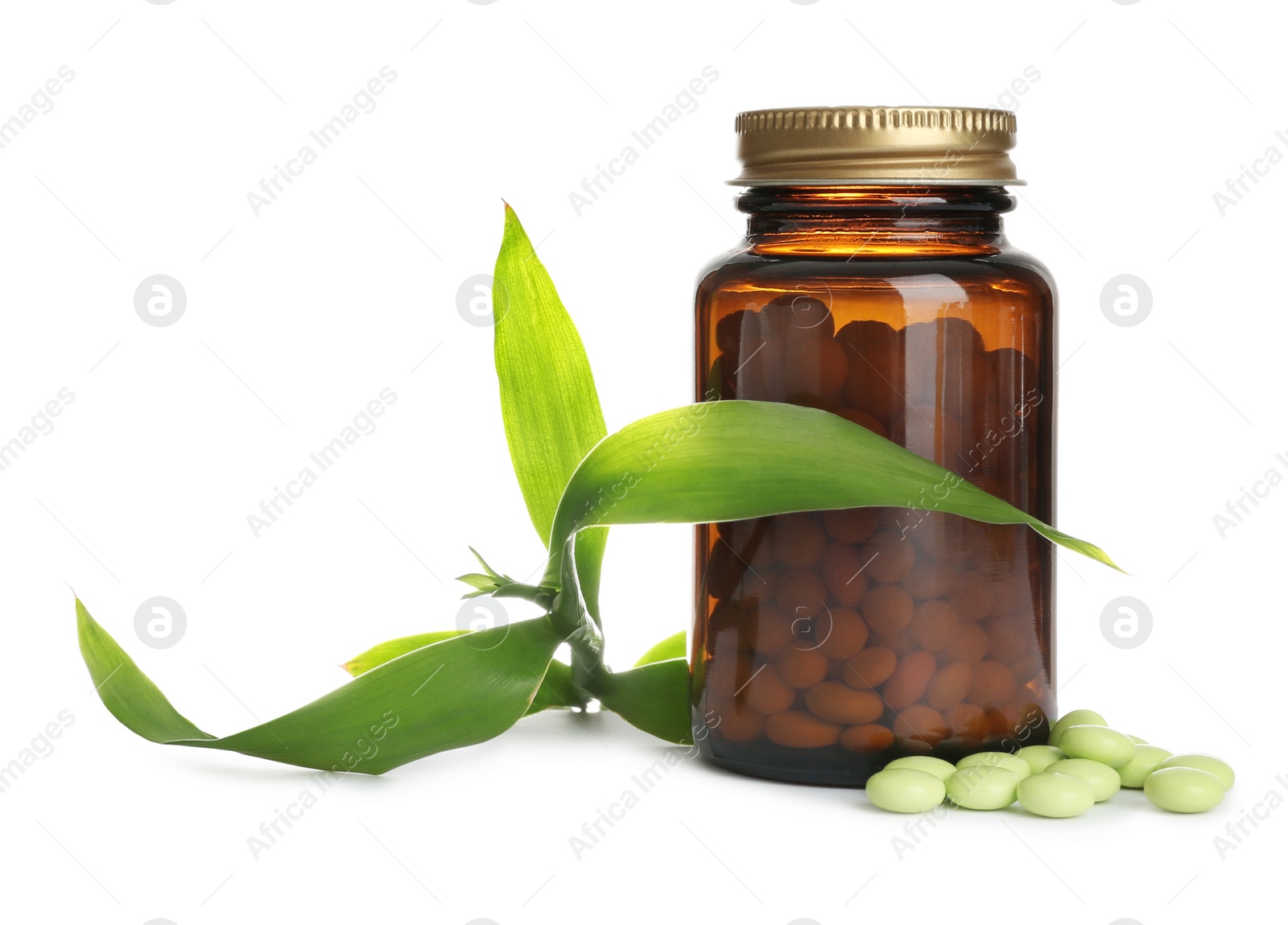 Photo of Bottle with vitamin pills and green leaves on white background