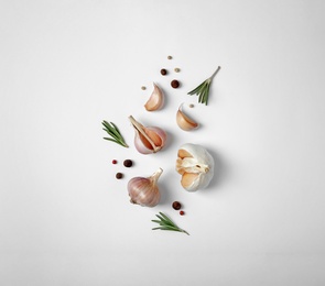 Photo of Composition with garlic, pepper and rosemary on white background, top view