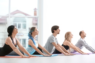 Group of people practicing yoga indoors