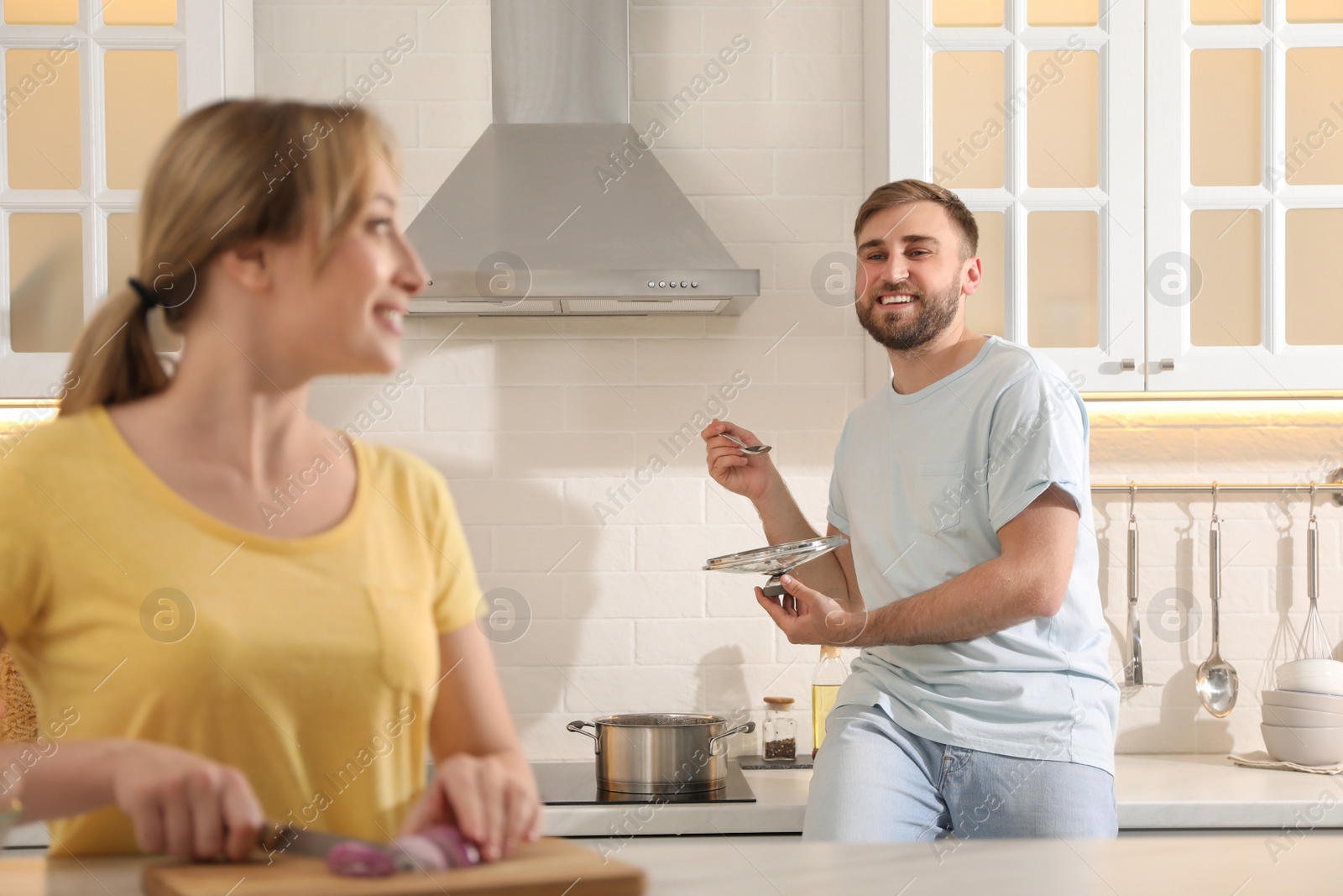 Photo of Young couple making bouillon in kitchen. Homemade recipe