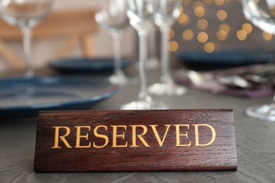 Table setting with RESERVED sign in restaurant