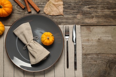 Stylish autumn table setting on wooden background, flat lay. Space for text