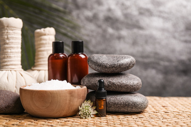 Photo of Beautiful spa composition with bath salt on wicker mat