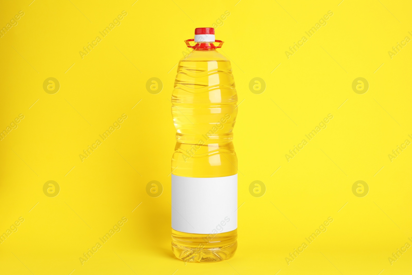 Photo of Bottle of cooking oil on yellow background