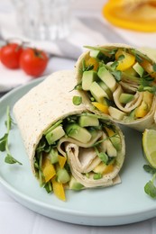 Delicious sandwich wraps with fresh vegetables on white tiled table