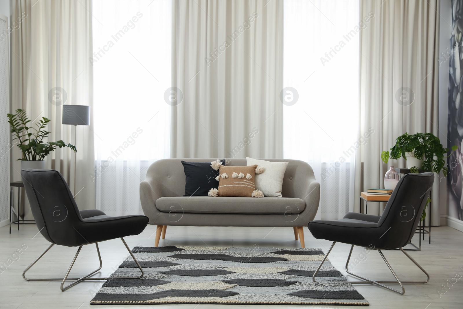 Photo of Modern living room interior with comfortable sofa and armchairs