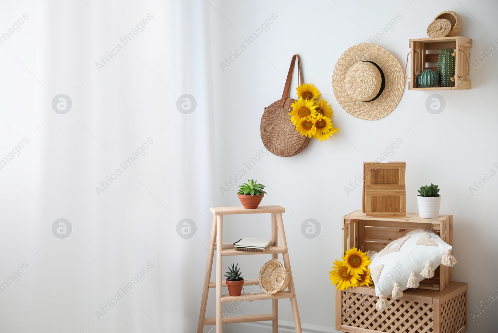 Photo of Bag with bouquet of beautiful sunflowers in stylish room interior