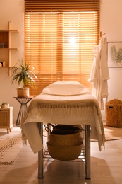 Stylish massage room interior in spa salon