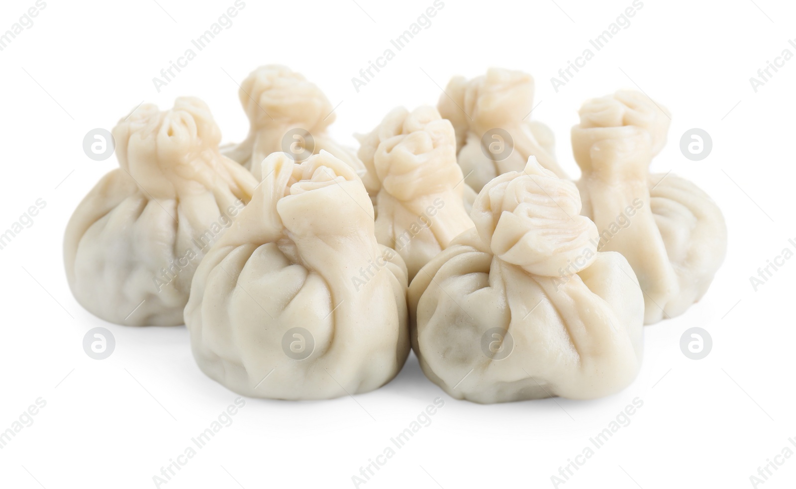 Photo of Many tasty khinkali (dumplings) isolated on white. Georgian cuisine