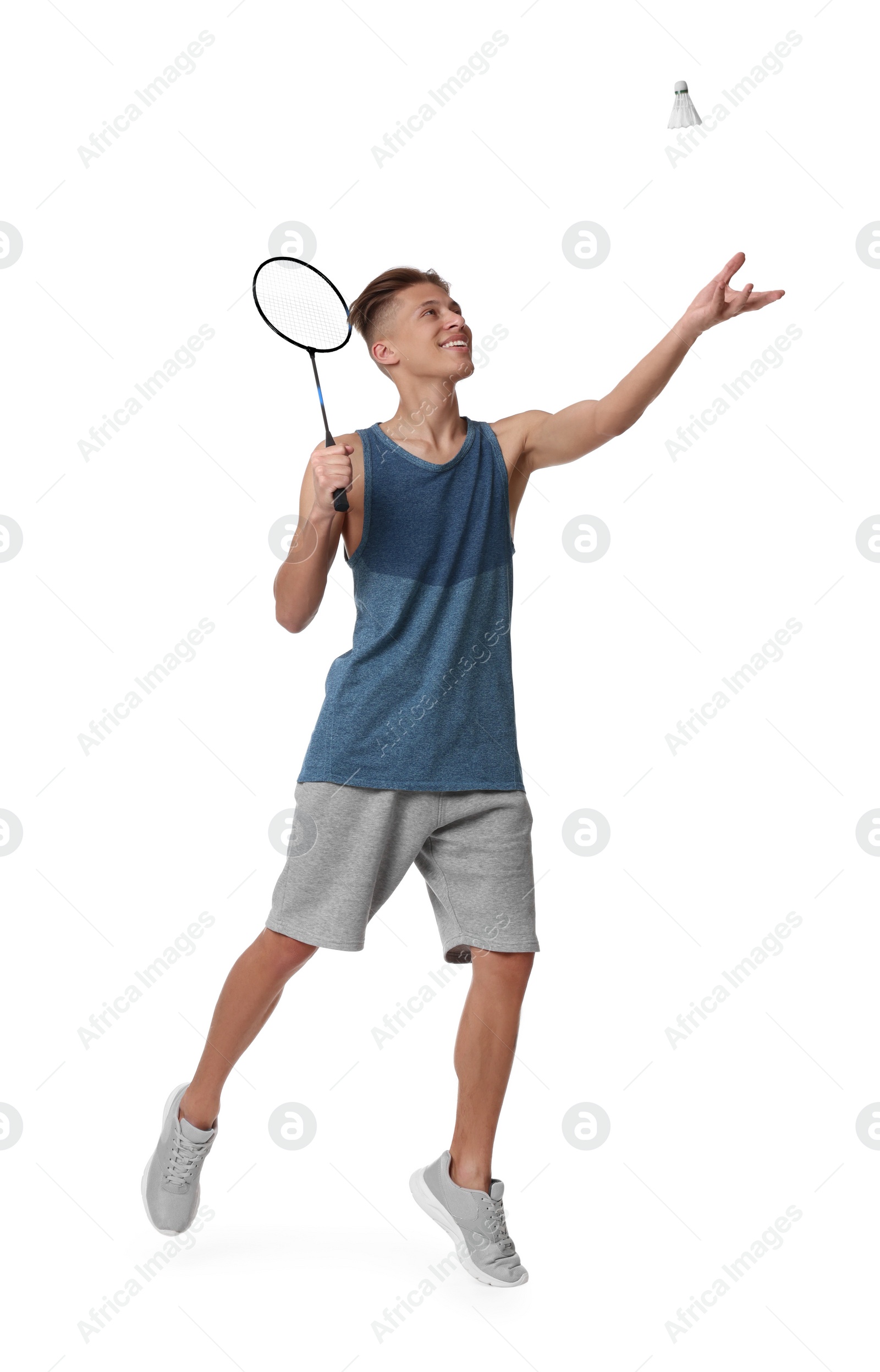 Photo of Young man playing badminton with racket and shuttlecock on white background