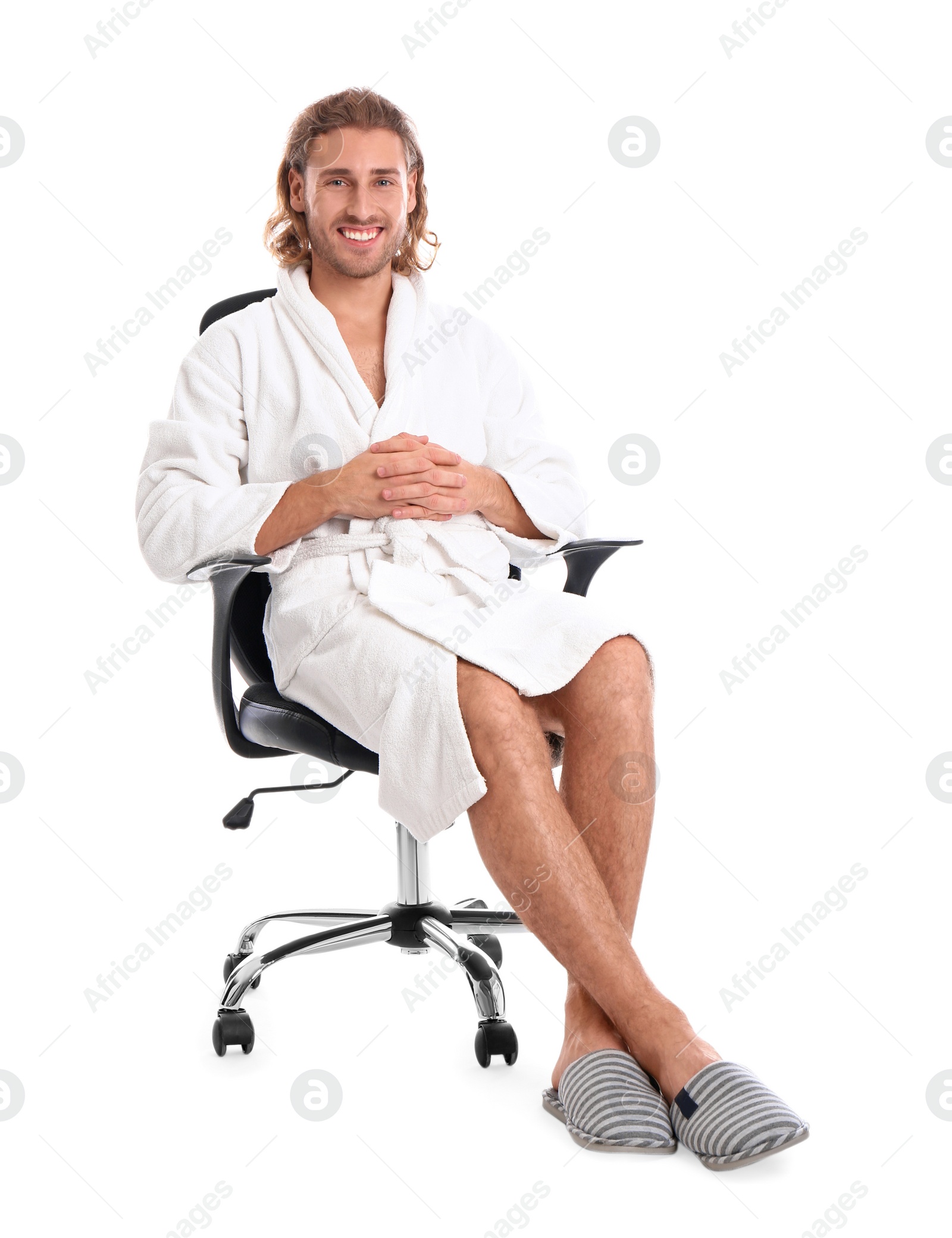 Photo of Young man in bathrobe on white background