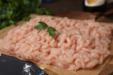 Fresh raw minced meat on wooden table, closeup