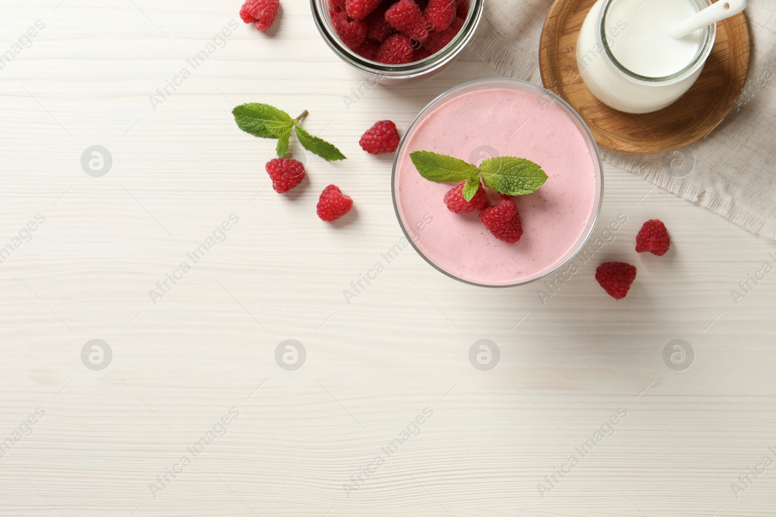 Photo of Delicious raspberry mousse with mint on white wooden table, flat lay. Space for text