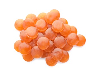 Photo of Many orange cough drops on white background, top view