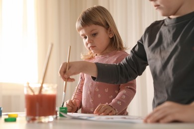 Cute little children drawing at light table indoors