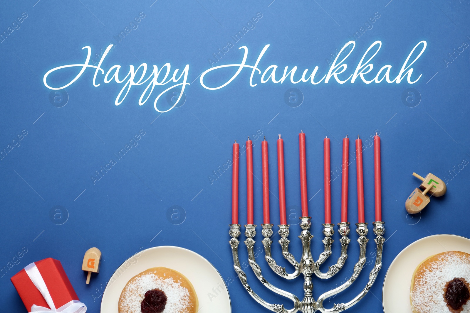 Image of Happy Hanukkah. Traditional menorah, candles, sufganiyot and dreidels on blue background, flat lay 