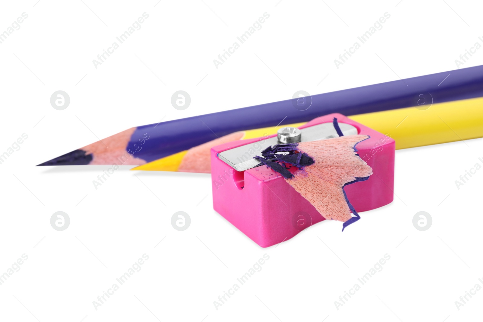Photo of Colorful pencils, sharpener and shavings on white background
