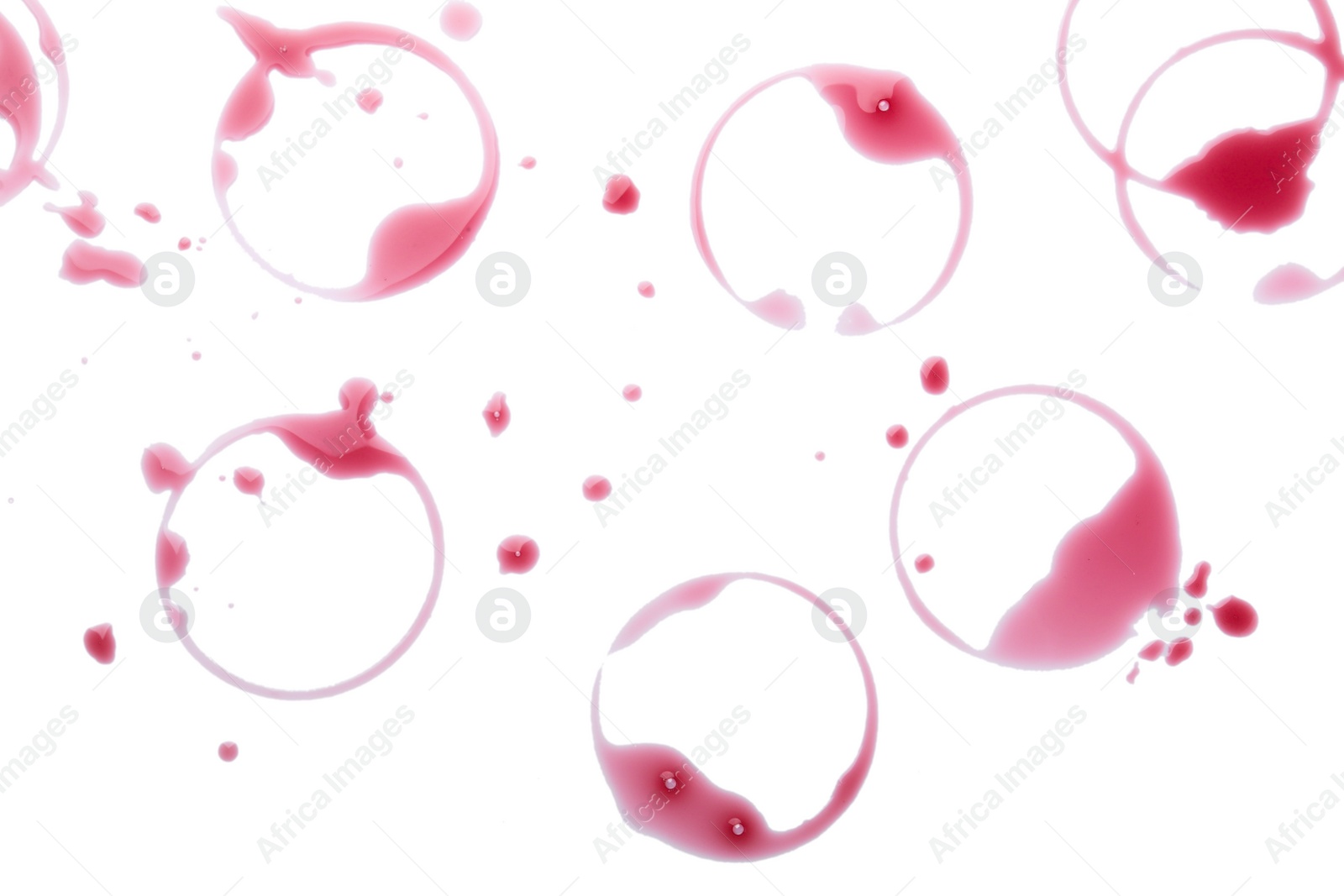 Photo of Many red wine rings and drops on white background, top view