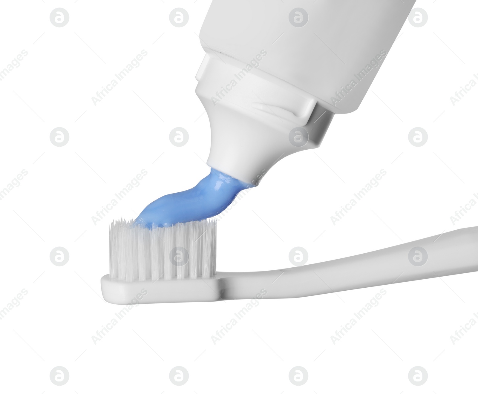 Photo of Applying paste on toothbrush against white background, closeup