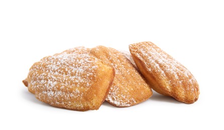 Photo of Delicious madeleine cakes with powdered sugar on white background