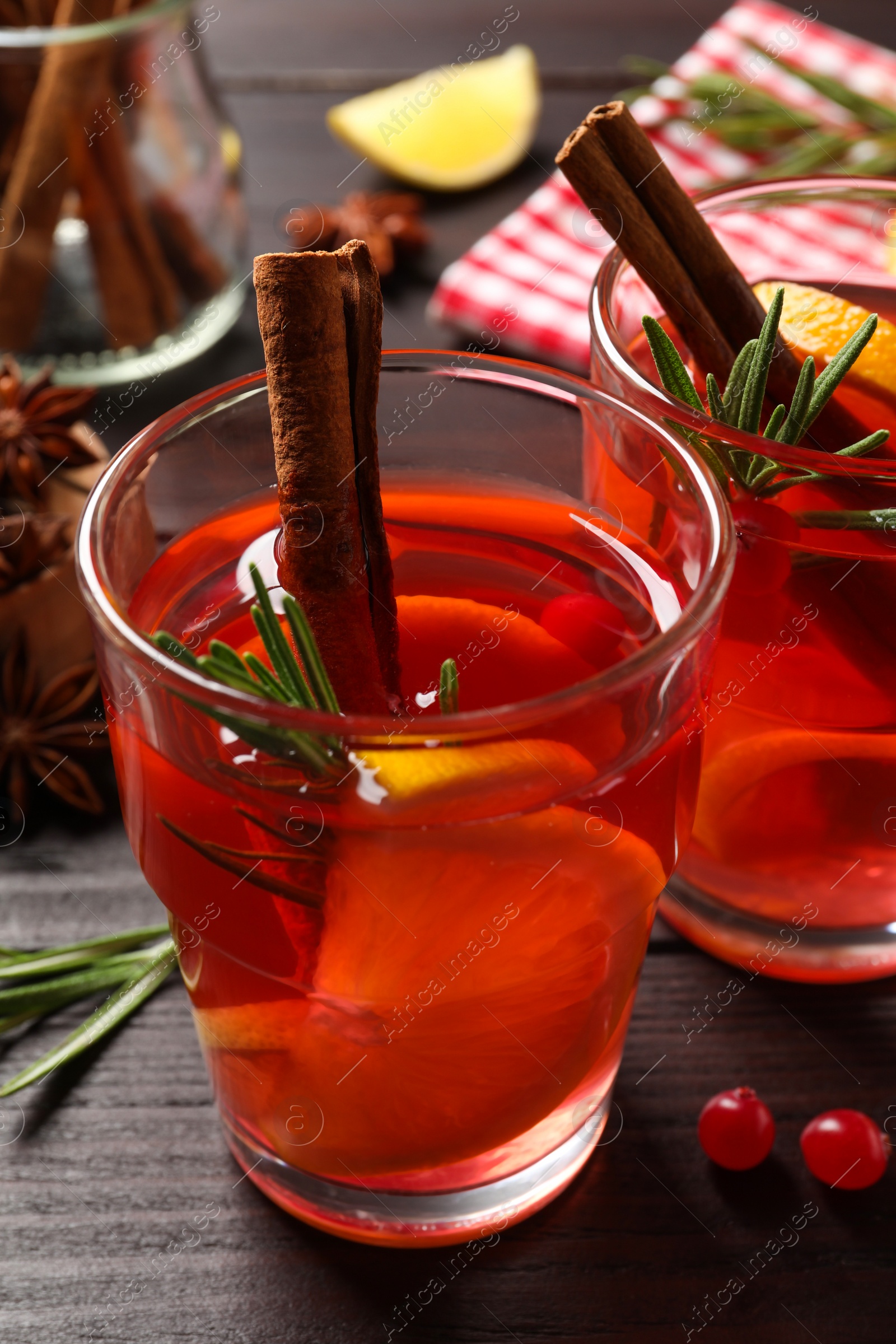 Photo of Aromatic punch drink and ingredients on wooden table