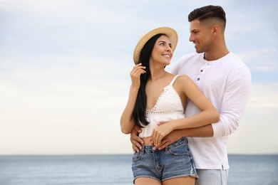 Photo of Lovely couple spending time together on beach. Space for text